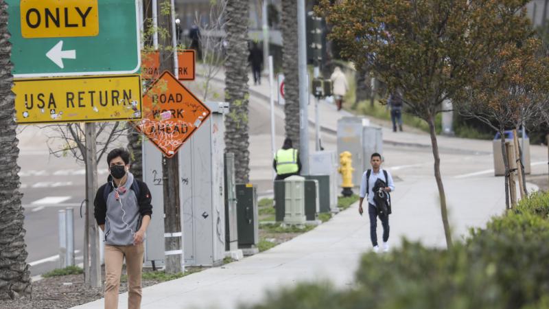 Pedestrians walk near the United States Port of Entry with Mexico.