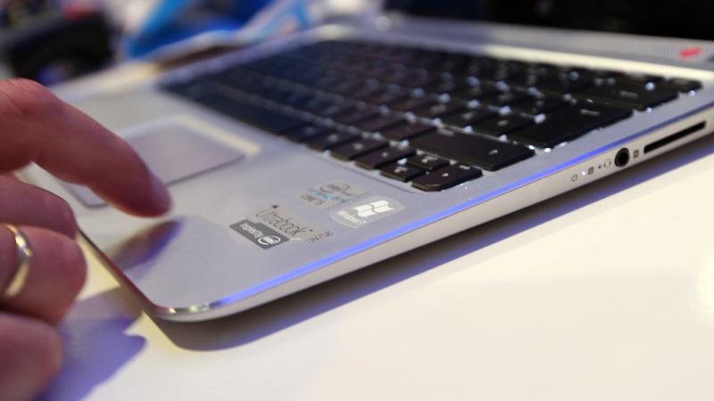 Person trying out HP laptop at a consumer electronics trade fair in Germany in 2012