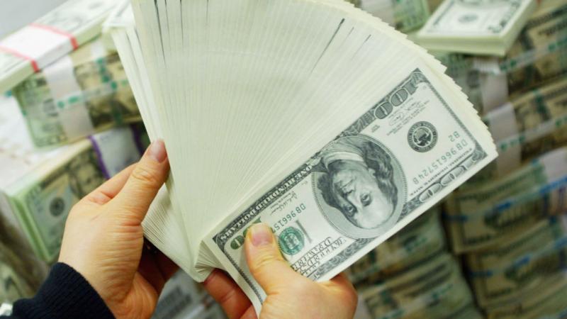 South Korean Banker carries US dollar bank notes at bank in South Korea in 2005