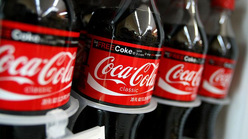 Coca-Cola bottles for sale in cooler. 