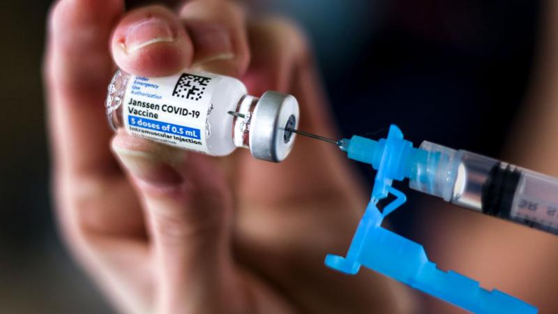 Person draws dose from vial of Johnson & Johnson COVID-19 vaccine