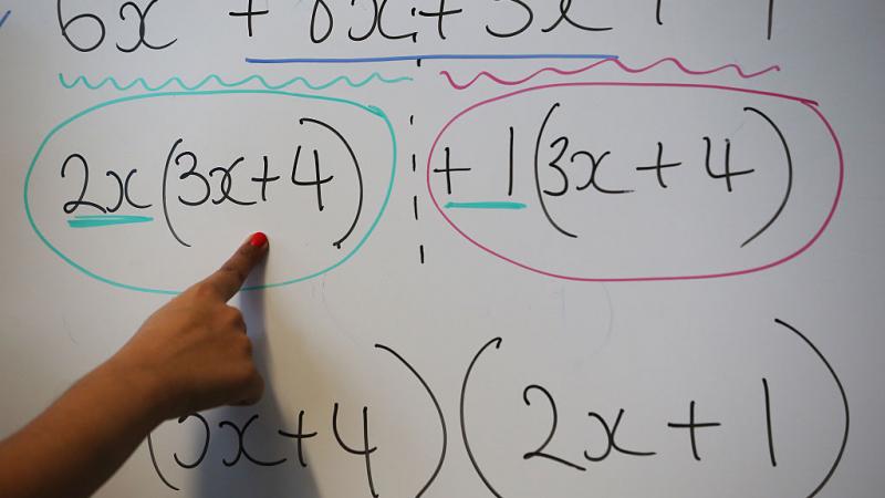 Teacher writes an equation in England in 2014