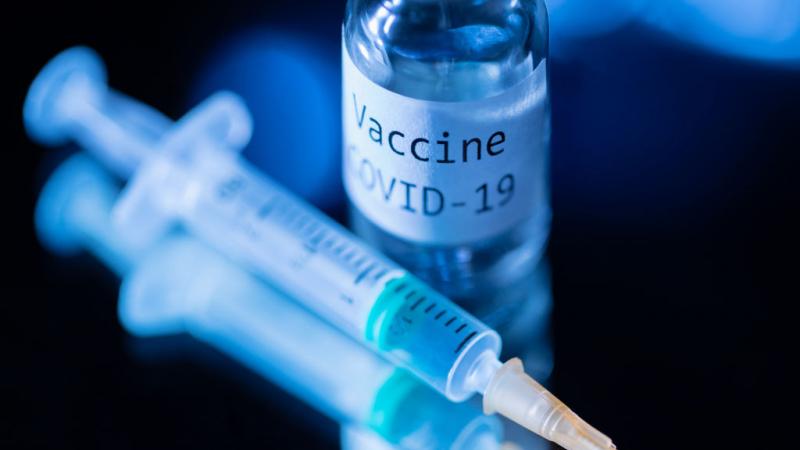Syringe and bottle reading "Vaccine COVID-19"