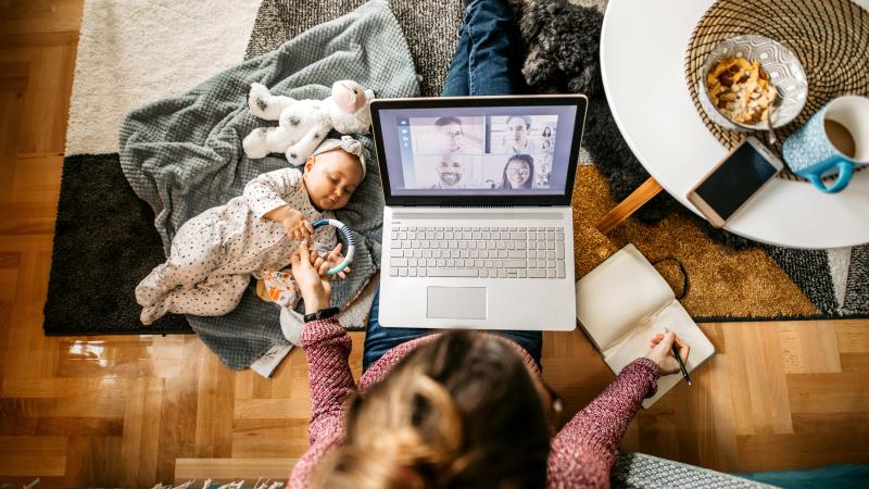 Woman teleworking with baby