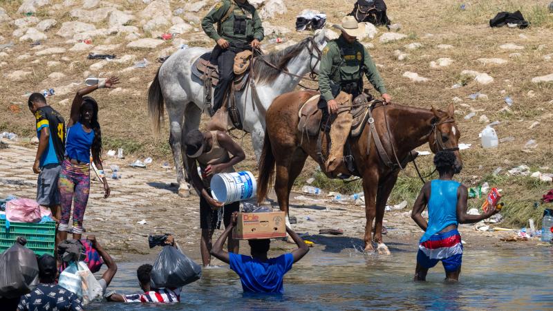 Horse-mounted Border Patrol agents with migrants, Rio Grande, Texas, Sept. 20, 2021