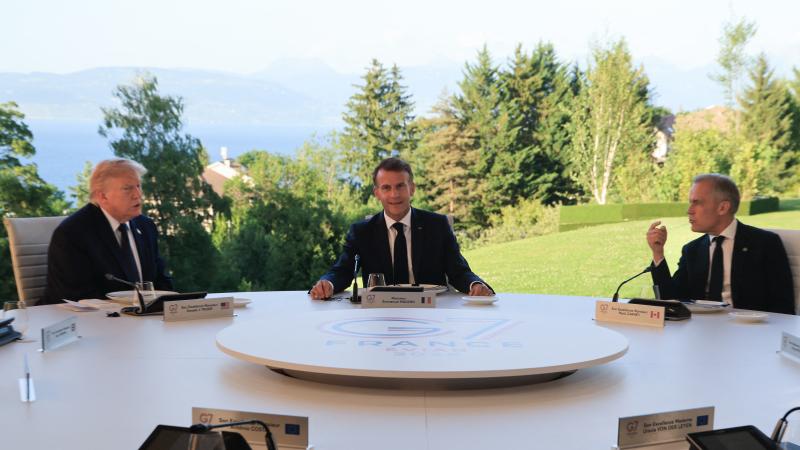 France's President Emmanuel Macron (C), US President Donald Trump (L) and Canada's Prime Minister Mark Carney attend a working dinner with G7 leaders