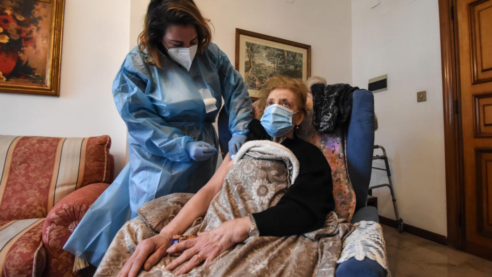 Woman over the age of 80 receives her COVID-19 vaccine in an at home vaccination in Italy.